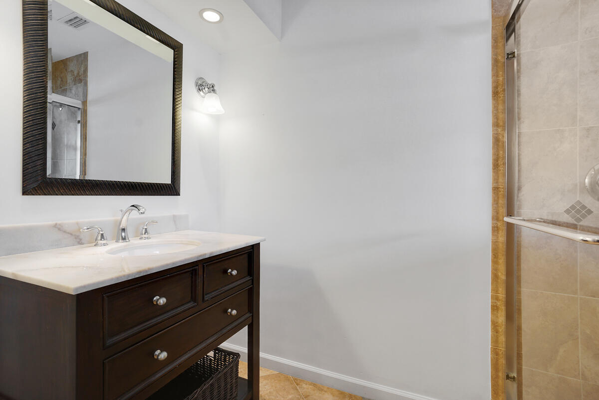 19842 Wilkinson Leas Road Jupiter, FL 33469 - Photo 58 of 75 a bathroom with a sink and a mirror