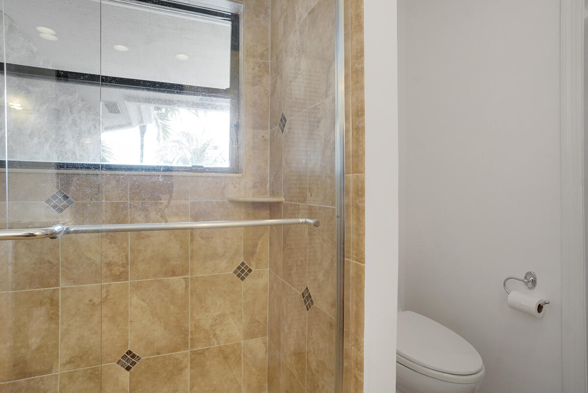 19842 Wilkinson Leas Road Jupiter, FL 33469 - Photo 59 of 75 a bathroom with a toilet and a shower