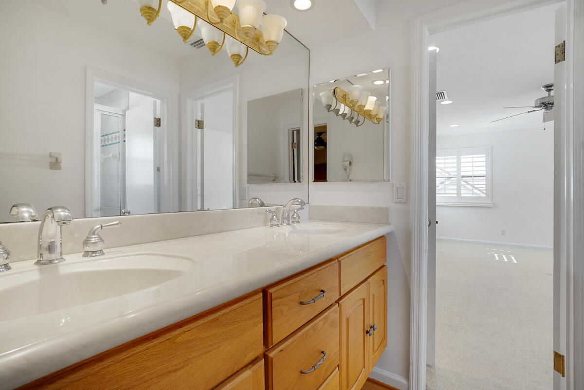 19842 Wilkinson Leas Road Jupiter, FL 33469 - Photo 60 of 75 a bathroom with a sink a vanity and a mirror