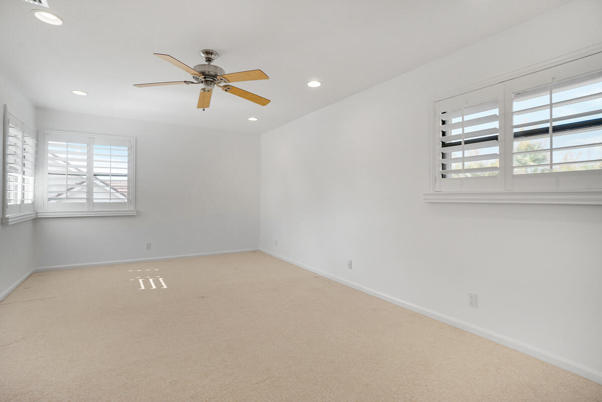 19842 Wilkinson Leas Road Jupiter, FL 33469 - Photo 61 of 75 an empty room with windows and fan
