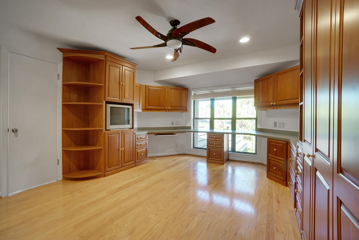 19842 Wilkinson Leas Road Jupiter, FL 33469 - Photo 65 of 75 a view of empty room with wooden floor and fan