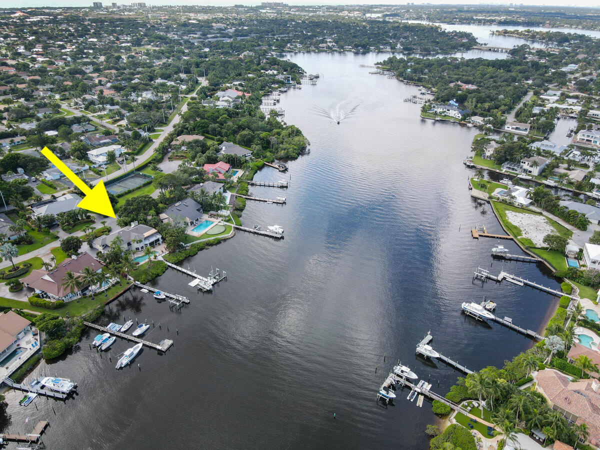 19842 Wilkinson Leas Road Jupiter, FL 33469 - Photo 68 of 75 an aerial view of a house with a yard and lake view