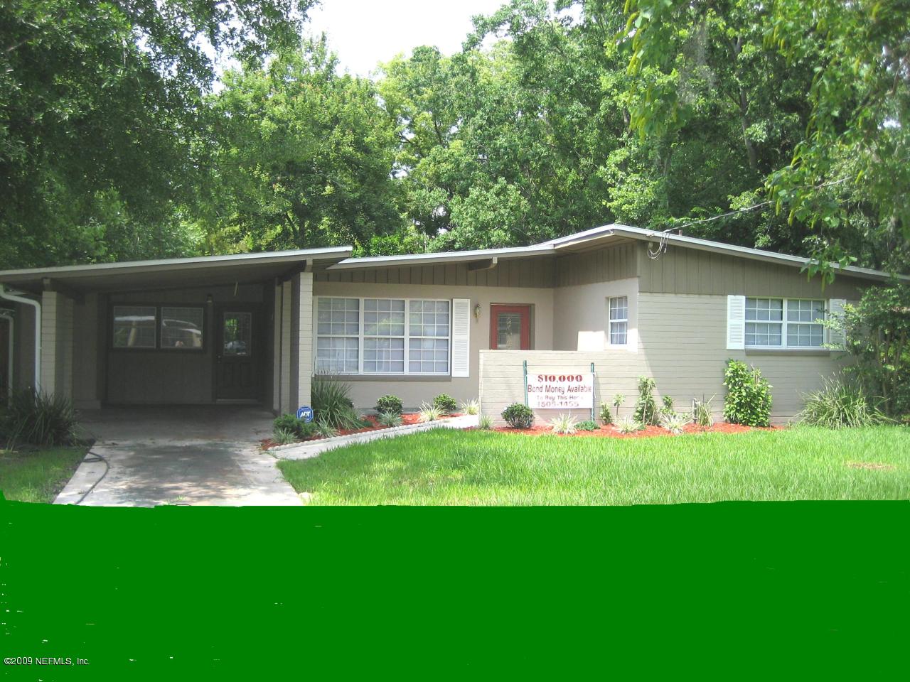 6943 Rollo Road Jacksonville, FL 32205 - Photo 1 of 13 a front view of a house with a yard