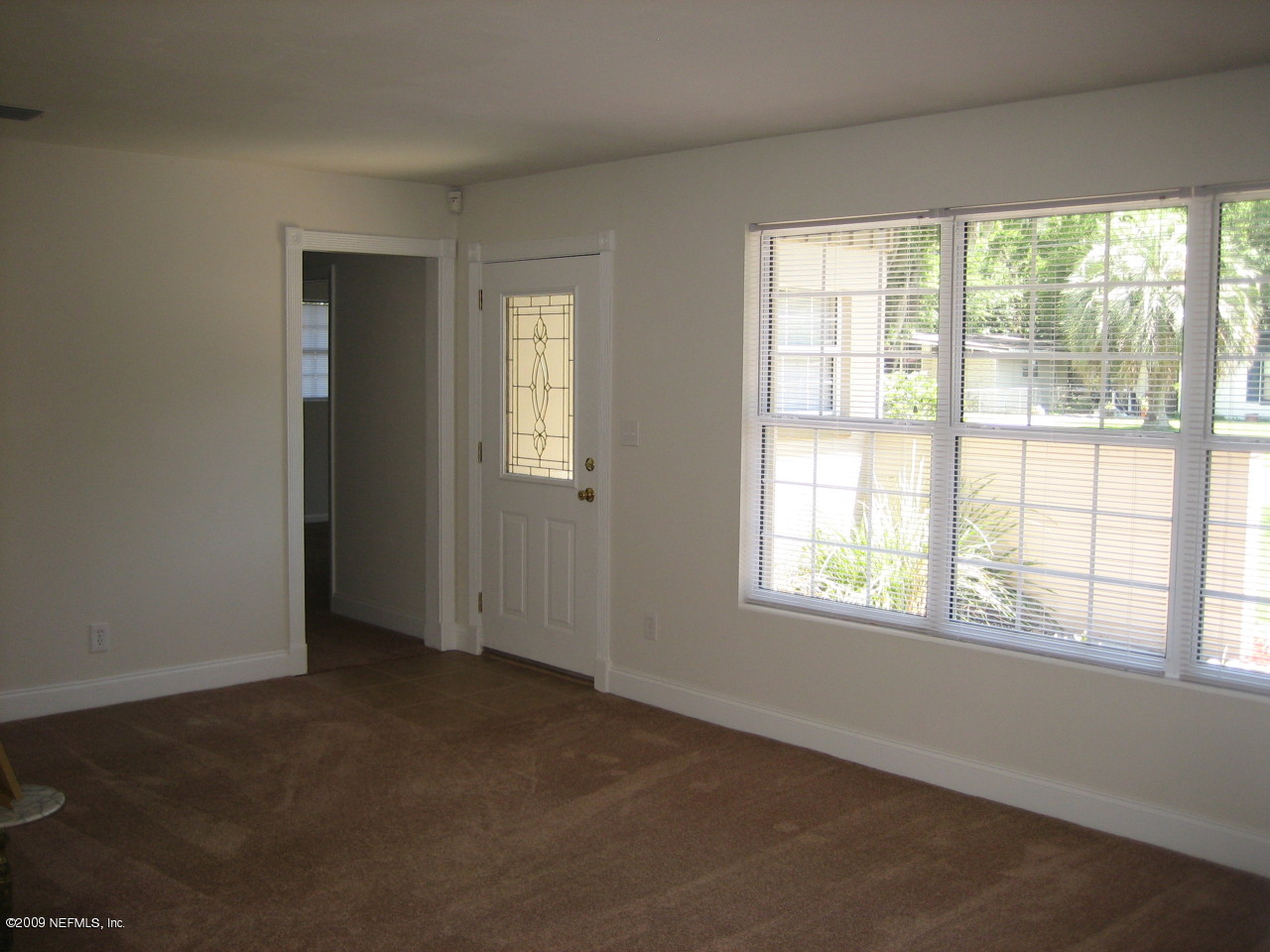 6943 Rollo Road Jacksonville, FL 32205 - Photo 3 of 13 an empty room with a window