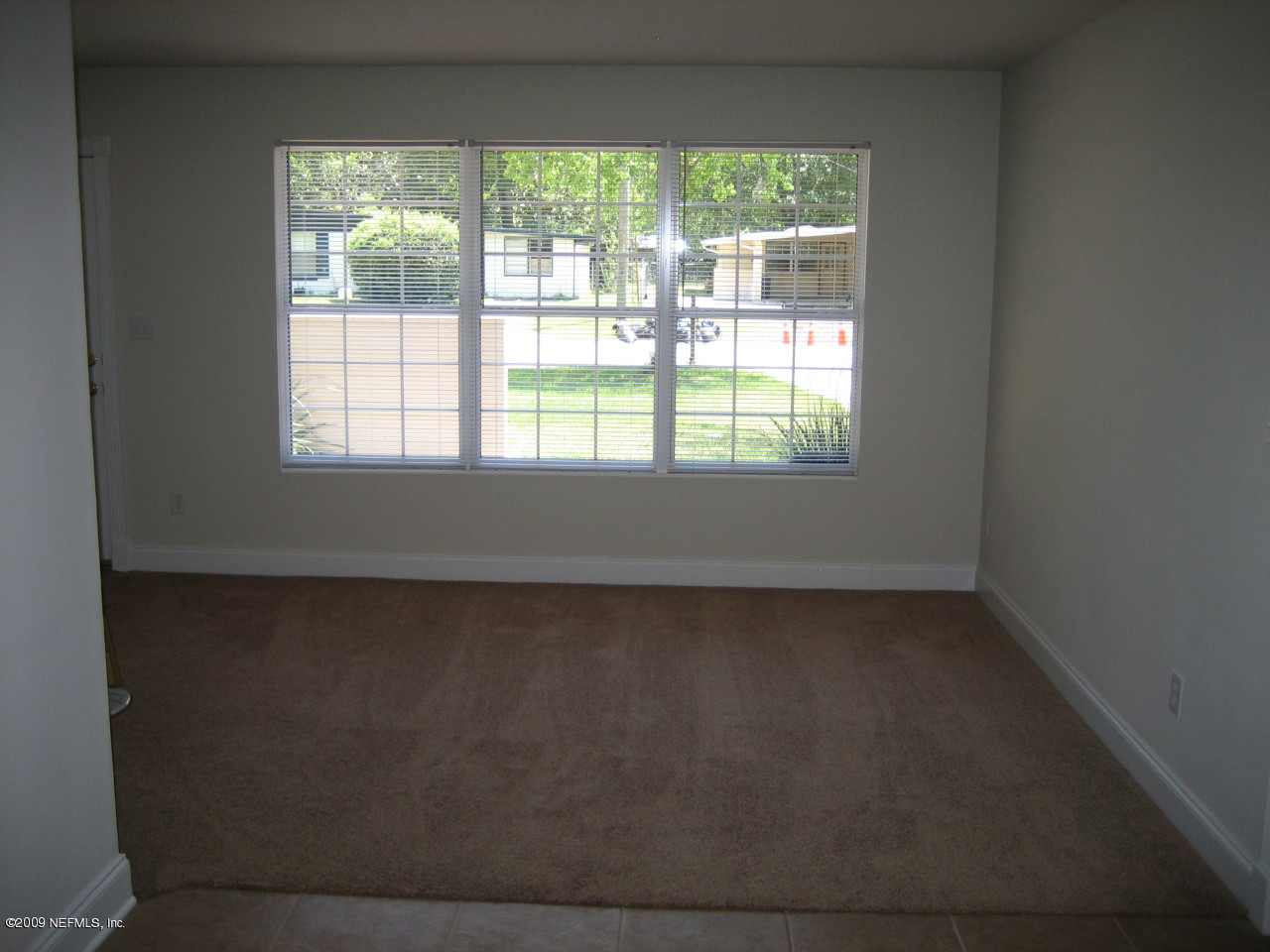 6943 Rollo Road Jacksonville, FL 32205 - Photo 4 of 13 an empty room with a window