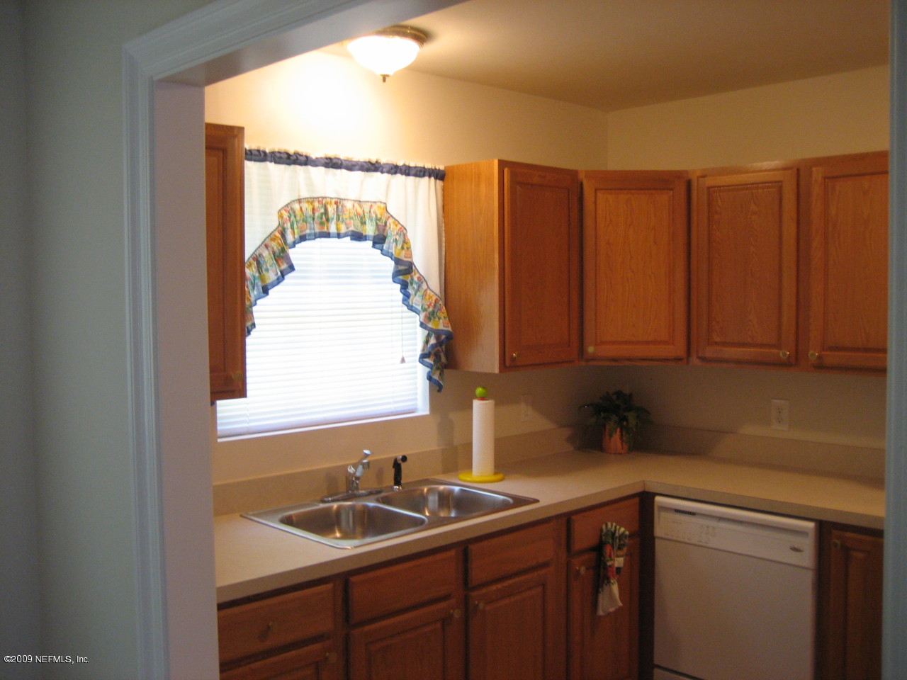 6943 Rollo Road Jacksonville, FL 32205 - Photo 5 of 13 a bathroom with a sink and a window