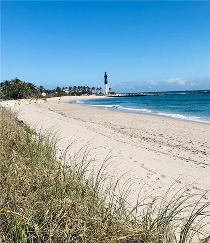 a view of a patio with dining table and chairs under an umbrella