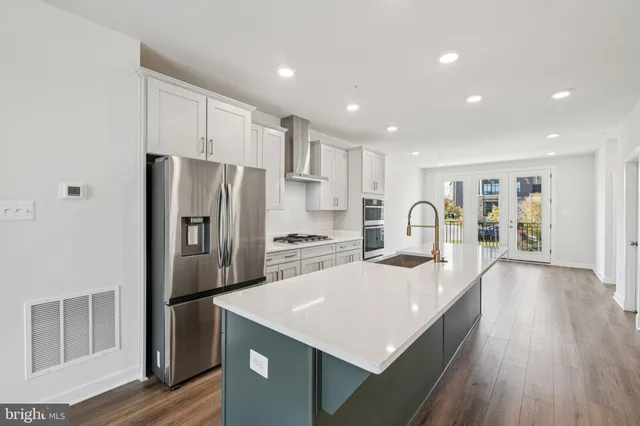 a kitchen with a refrigerator a sink and cabinets