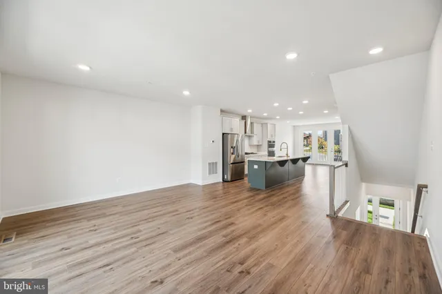a view of kitchen and kitchen with a refrigerator