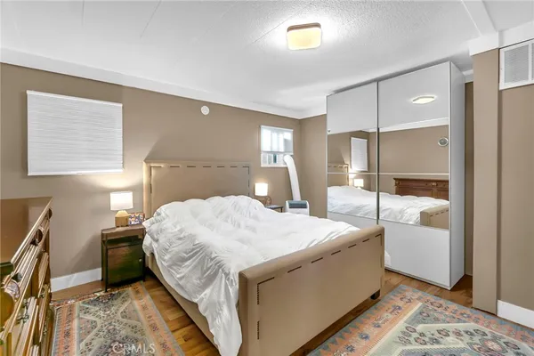 a bedroom with a bed and a dresser