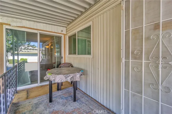 a view of a patio with table and chairs