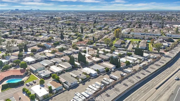 an aerial view of residential houses with city view