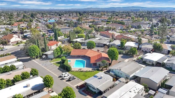 an aerial view of a house with a yard and potted plants
