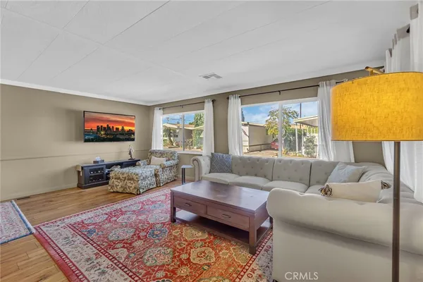a living room with furniture and a large window