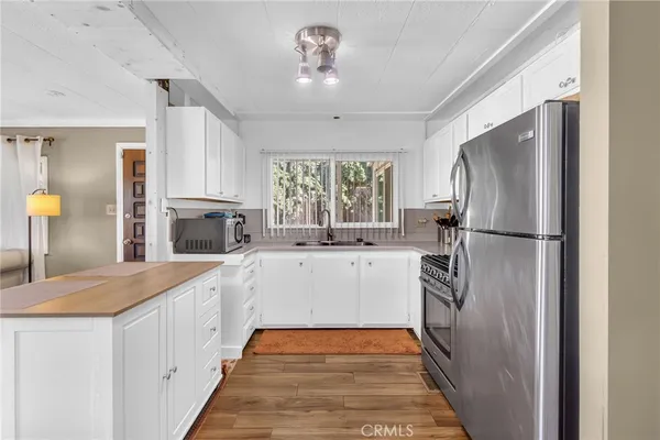 a large white kitchen with a large window