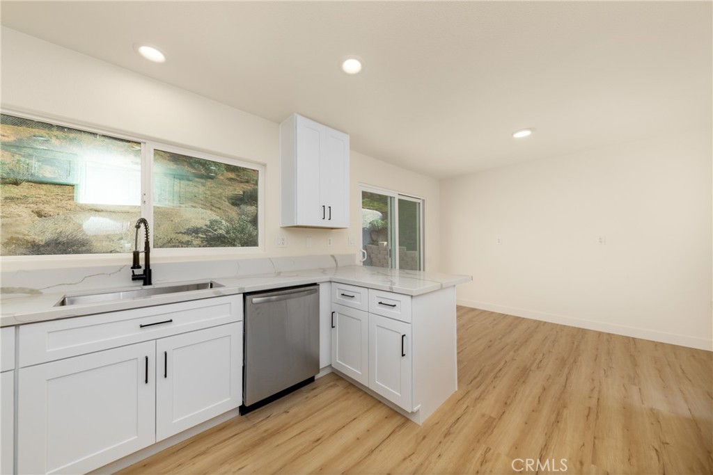 16322 Pick Place Riverside, CA 92504 - Photo 12 of 35 a view of a center island wooden floor and windows in a room