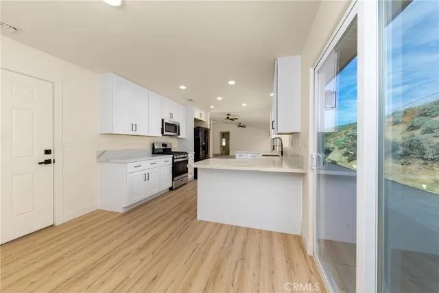 a kitchen with white cabinets and white appliances
