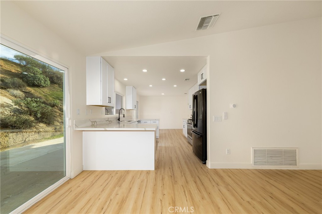 16322 Pick Place Riverside, CA 92504 - Photo 15 of 35 a view of kitchen with granite countertop window and wooden floor