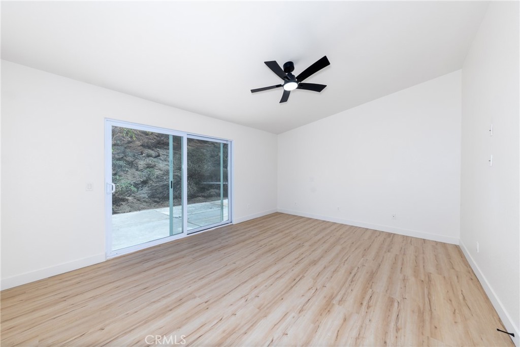 16322 Pick Place Riverside, CA 92504 - Photo 19 of 35 a view of empty room with wooden floor and fan