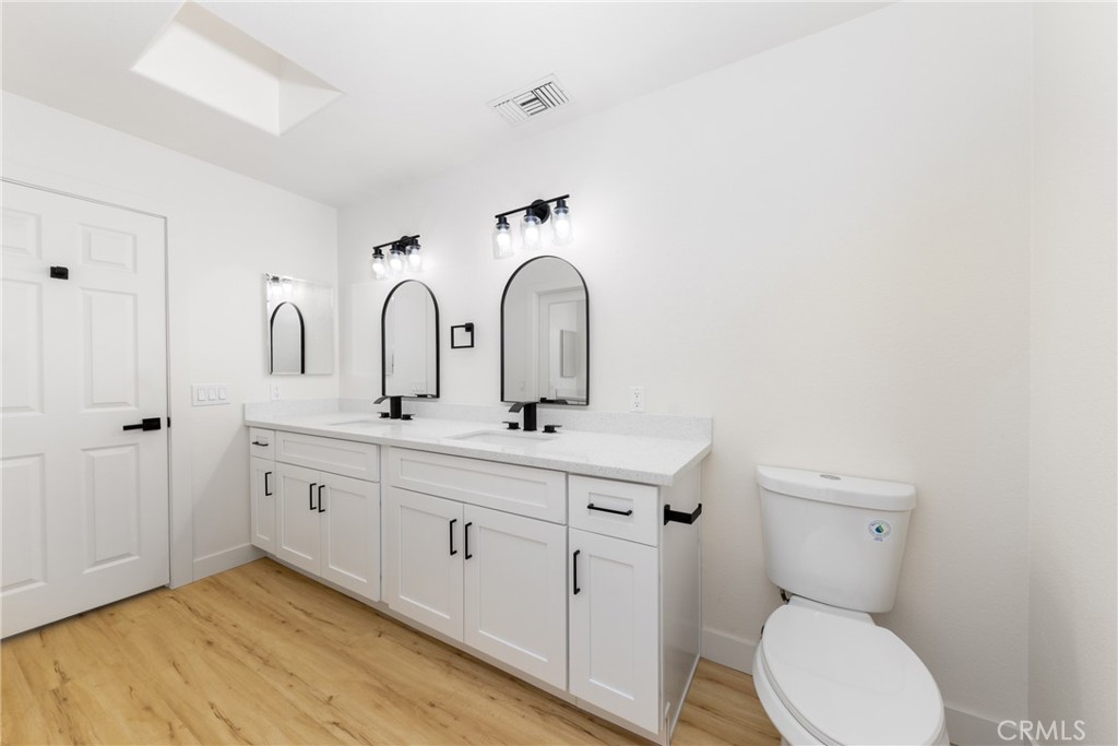 16322 Pick Place Riverside, CA 92504 - Photo 21 of 35 a bathroom with a toilet sink and mirror