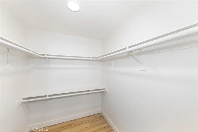 a view of a room with a ceiling fan and wooden floor