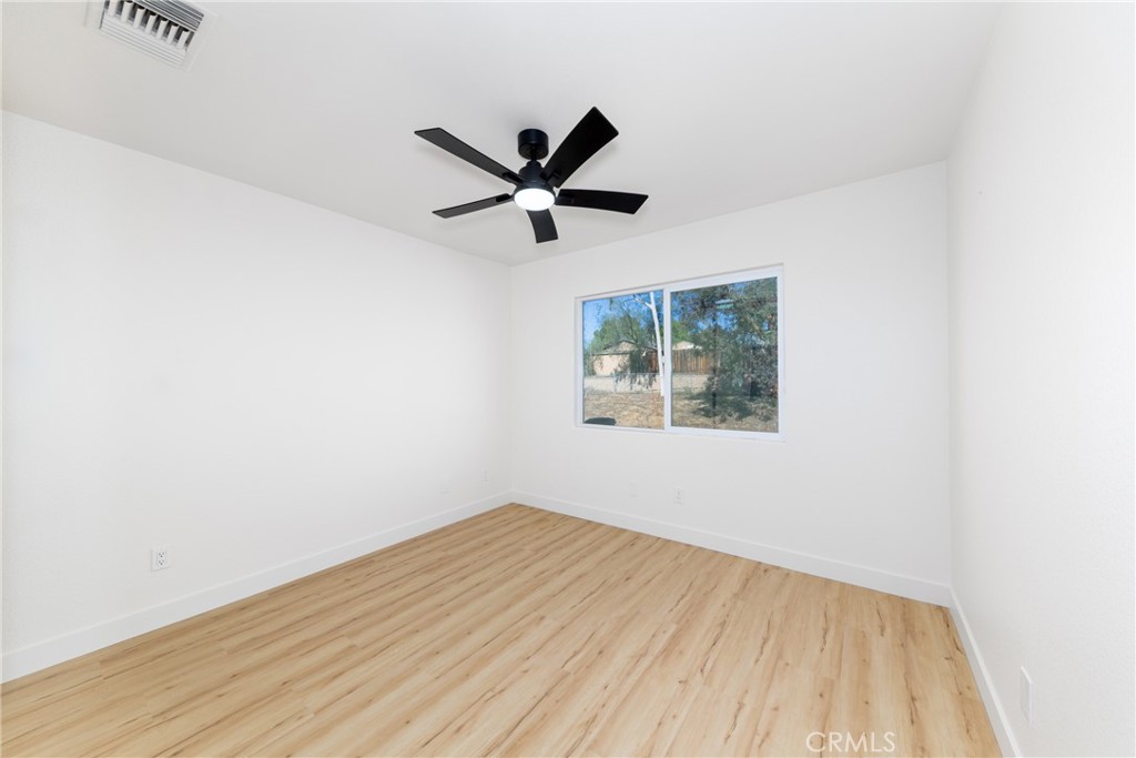 16322 Pick Place Riverside, CA 92504 - Photo 28 of 35 an empty room with a window and a fan