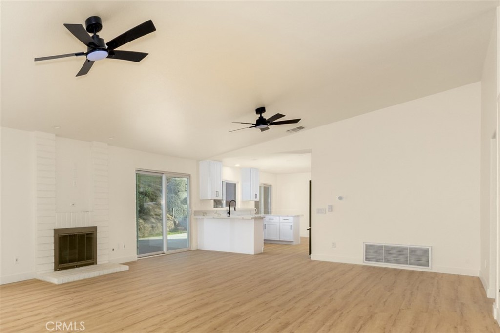16322 Pick Place Riverside, CA 92504 - Photo 9 of 35 a view of a livingroom with a ceiling fan wooden floor and a ceiling fan