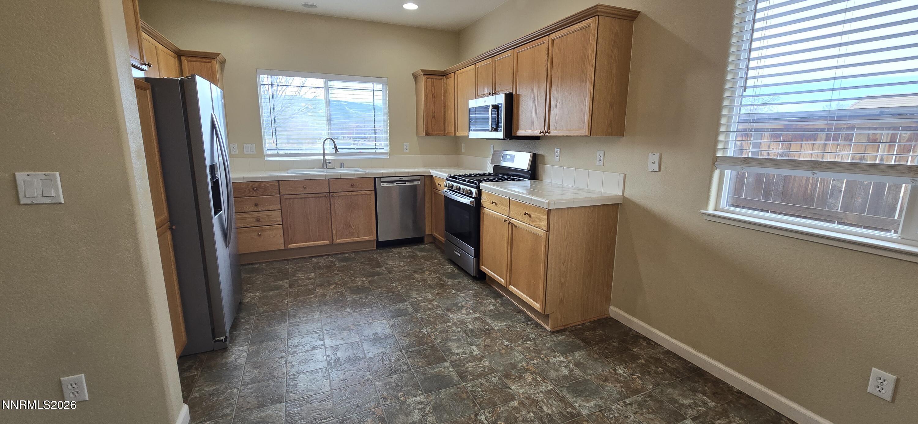 10210 Robilee Drive Reno, NV 89521 - Photo 16 of 56 a kitchen with a sink stove and refrigerator