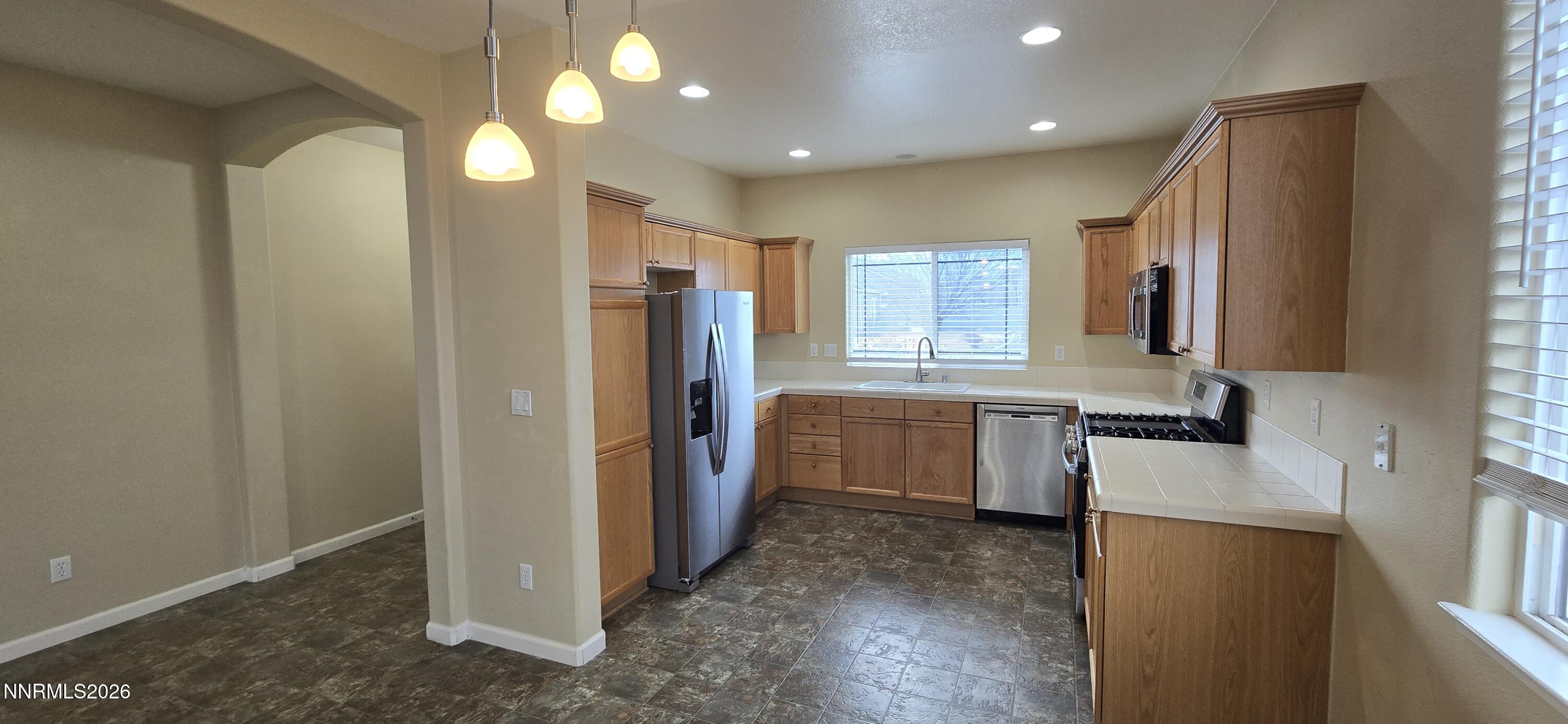 10210 Robilee Drive Reno, NV 89521 - Photo 18 of 56 a kitchen with a refrigerator and a sink