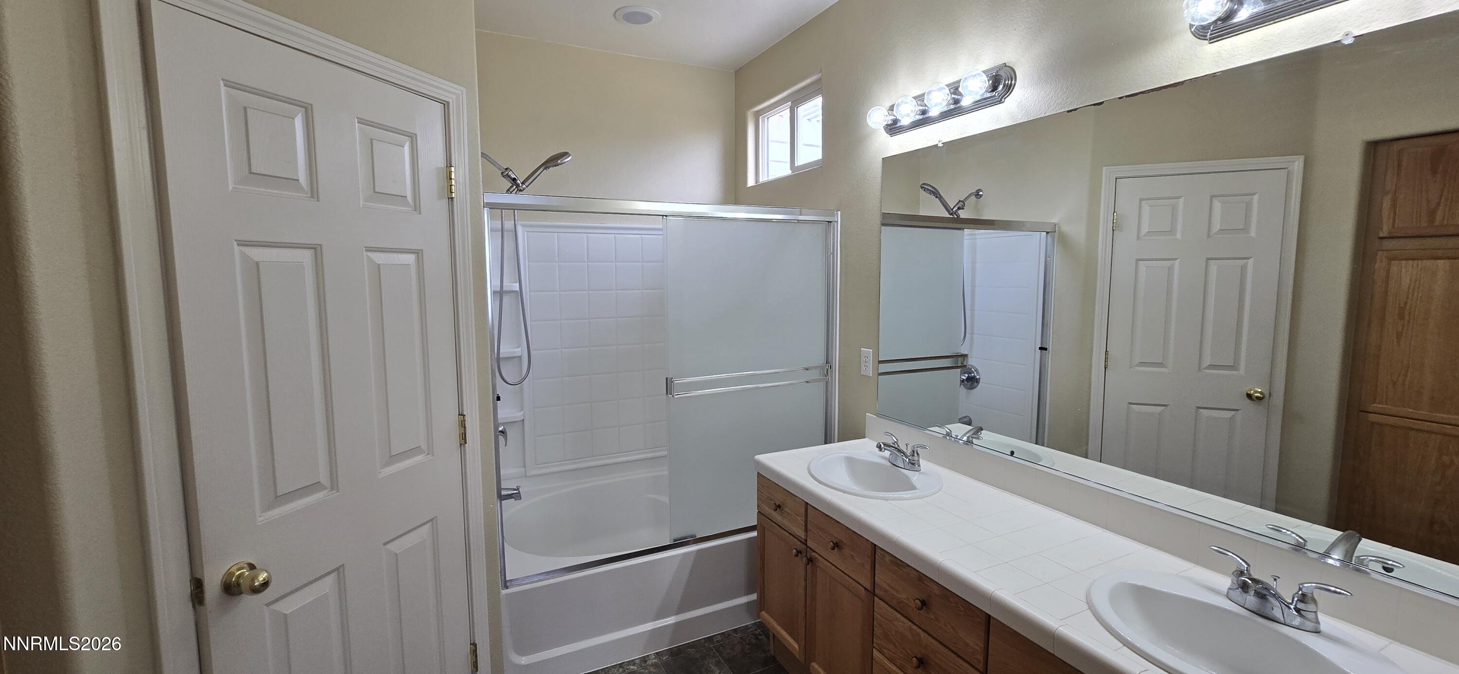 10210 Robilee Drive Reno, NV 89521 - Photo 27 of 56 a bathroom with a sink and a mirror