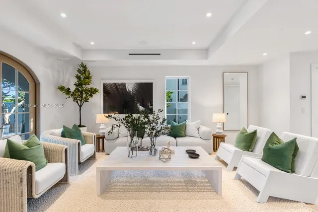 a living room with furniture a rug and a flat screen tv