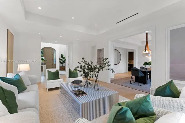 a large kitchen with stainless steel appliances a large counter top a stove and a sink