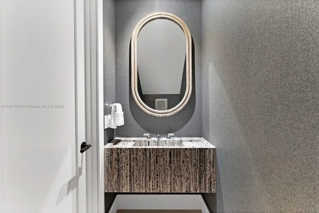 a bathroom with a granite countertop sink a mirror and a shower
