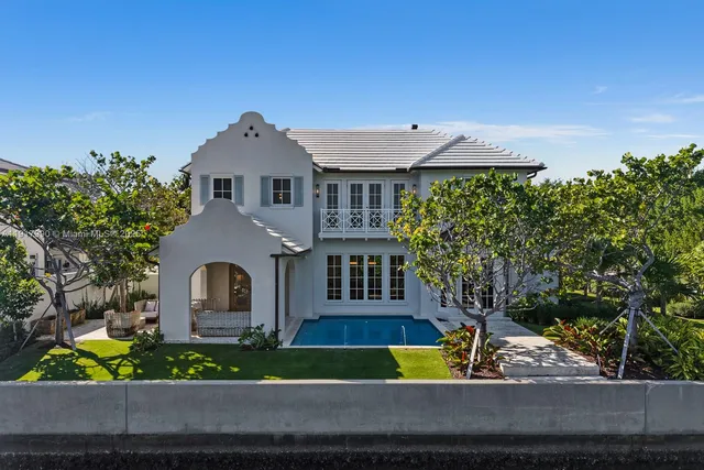 an aerial view of a city with lots of residential buildings and mountain view in back