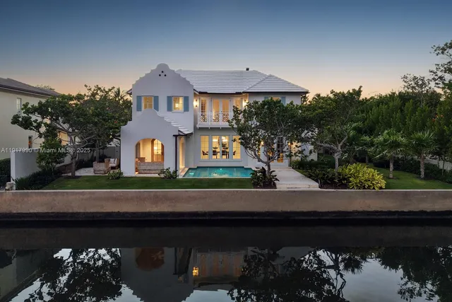 an aerial view of house with yard and ocean view