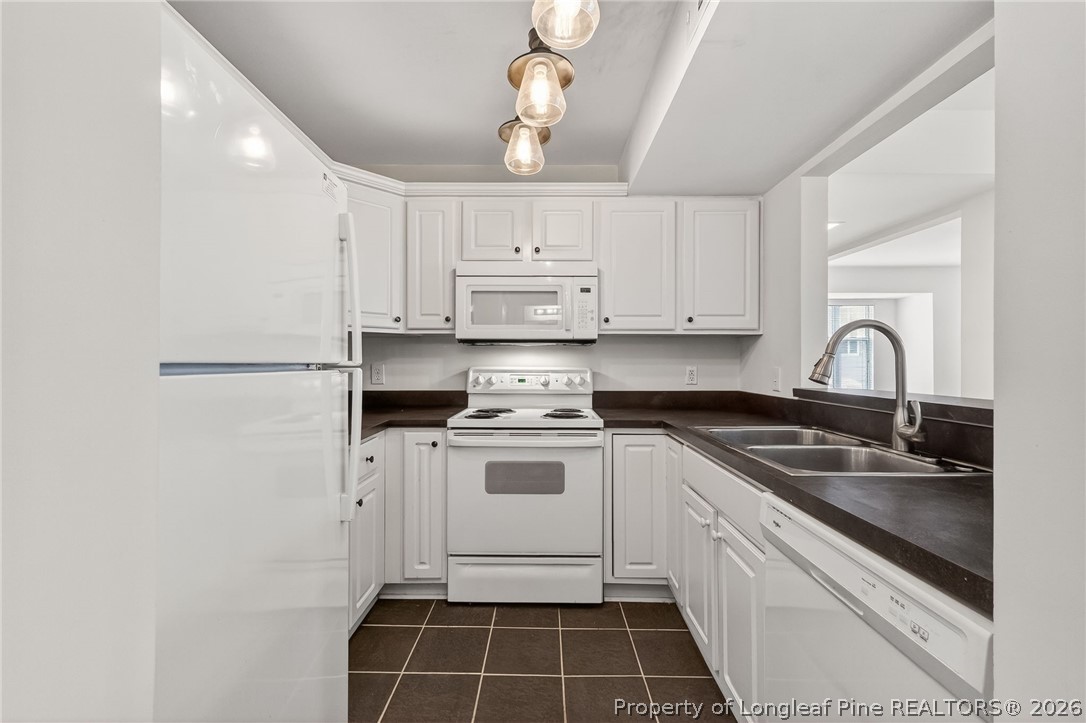 1221 Westview Lane, Unit 301 Raleigh, NC 27605 - Photo 23 of 32 a kitchen with a sink stove and cabinets