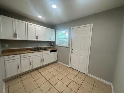 a kitchen with a sink and cabinets