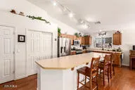 a large kitchen with lots of counter space and wooden floor