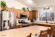 a living room with furniture and a kitchen
