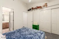 a bedroom with a bed a table and a chandelier