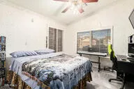 a bedroom with a bed a dresser and a book shelf