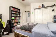 a bathroom with a double vanity sink a large mirror and a bathtub