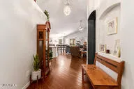 a view of a living room with a floor to ceiling window and wooden floor