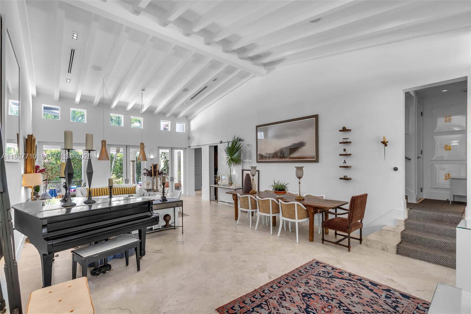 140 Hampton Lane Key Biscayne, FL 33149 - Photo 2 of 44 The spacious room features a living room and dining room with vaulted ceilings and high ceilings.