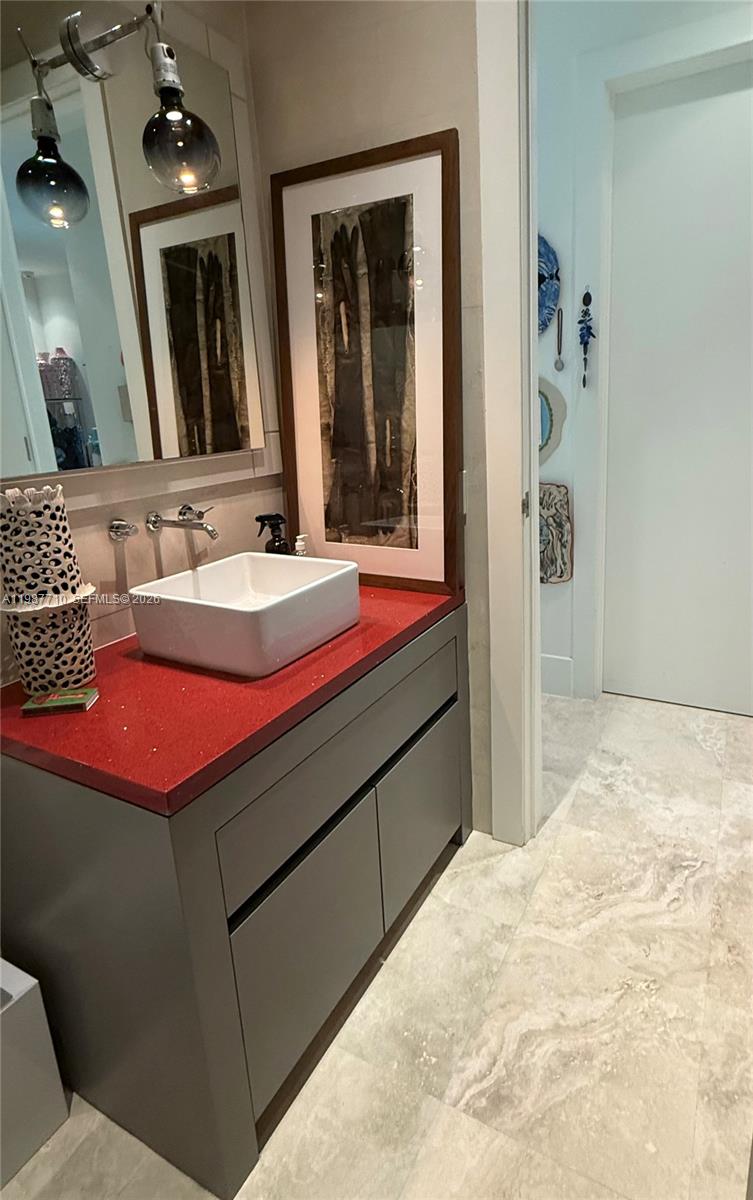 140 Hampton Lane Key Biscayne, FL 33149 - Photo 24 of 43 a bathroom with a sink and a mirror