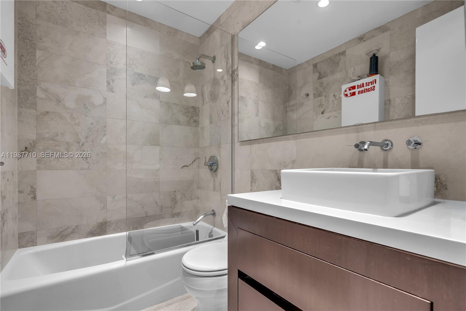 140 Hampton Lane Key Biscayne, FL 33149 - Photo 27 of 43 a bathroom with a sink a toilet and bathtub