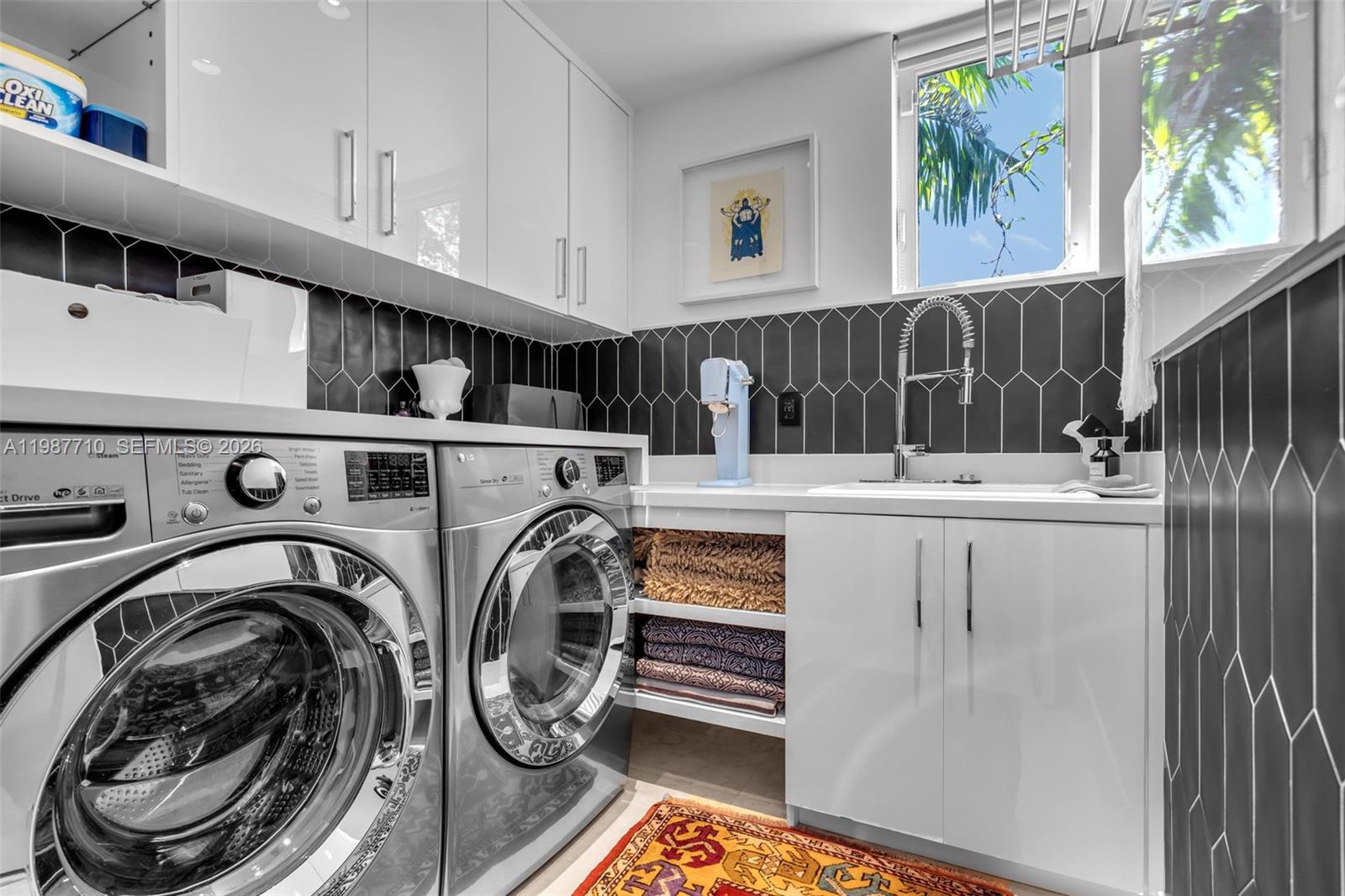 140 Hampton Lane Key Biscayne, FL 33149 - Photo 29 of 44 A built-in laundry room fixture, including a water faucet, is installed within the cabinets.