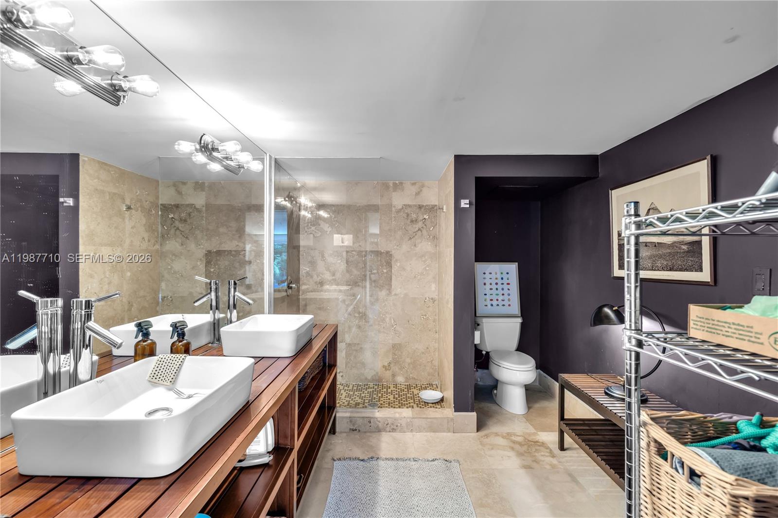 140 Hampton Lane Key Biscayne, FL 33149 - Photo 32 of 43 a bathroom with a double vanity sink a toilet a mirror and shower