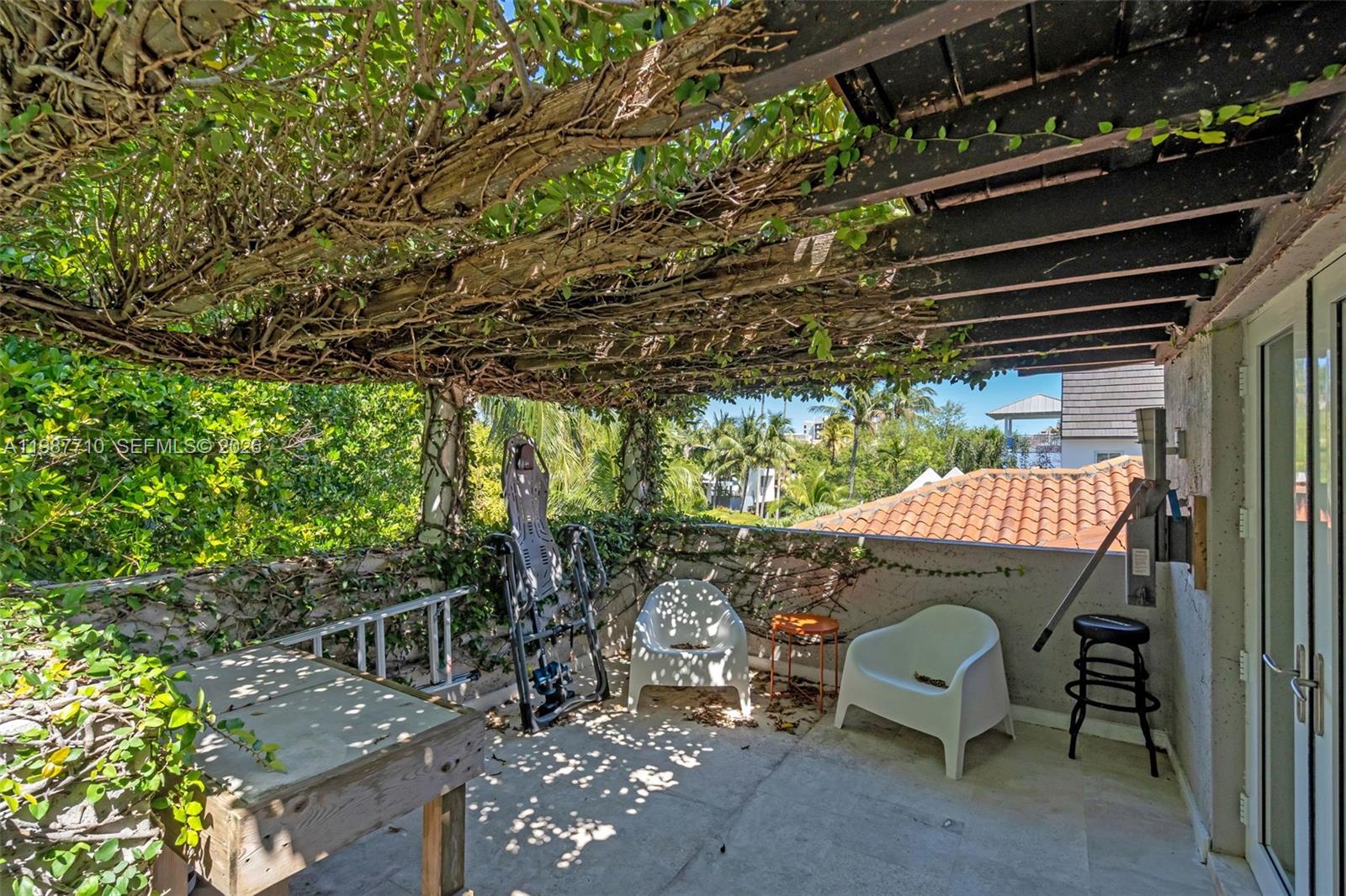 140 Hampton Lane Key Biscayne, FL 33149 - Photo 40 of 44 Upper veranda with “roof” of fig vines.
