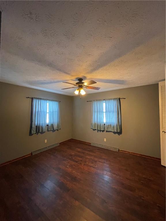 827 Georgetown Road Sandy Lake, PA 16145 - Photo 13 of 20 a view of an empty room with wooden floor and a window